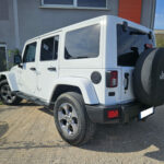 Jeep Wrangler Unlimited Sahara V6 3.6 285 ch Pentastar BVA — vue trois-quarts arrière